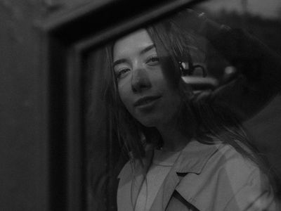 Silhouette of a person in a balance pose against a window